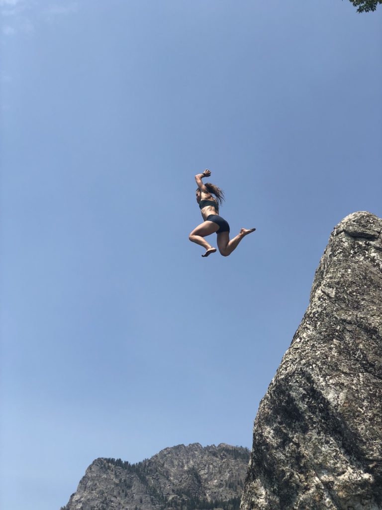 Emily rock jumping at Phelps Lake