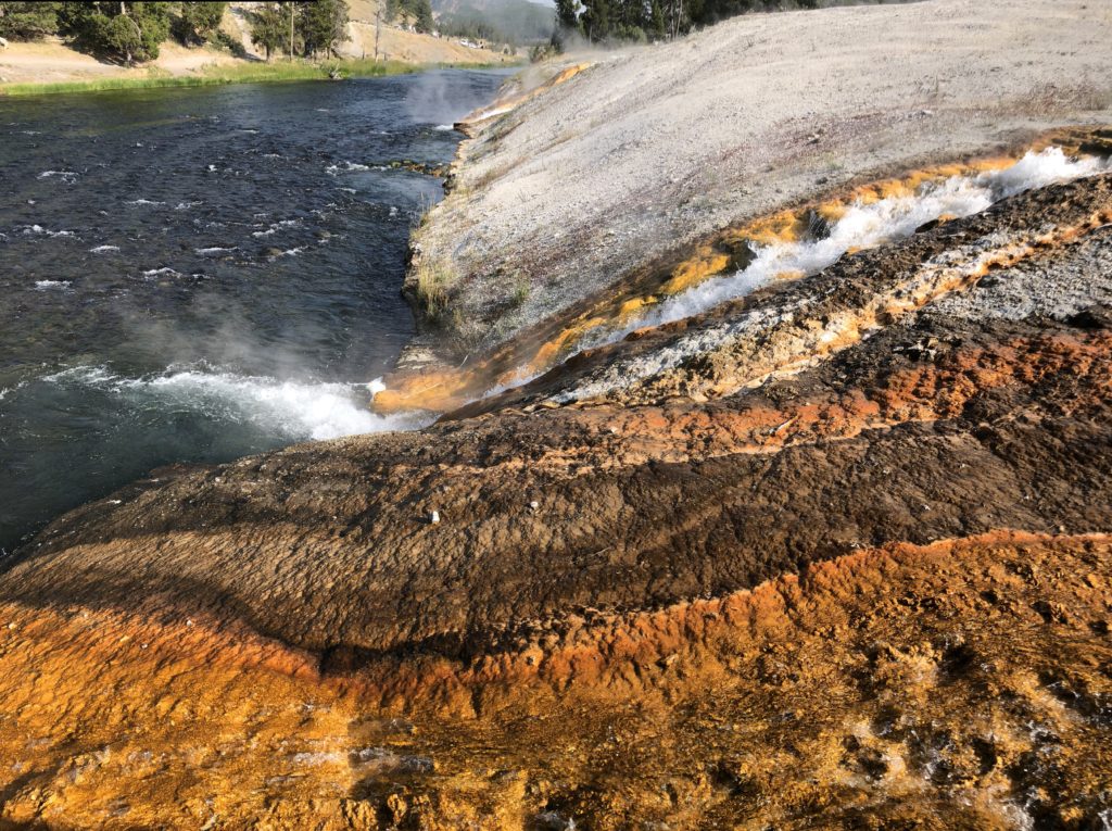 Steamboat Geyser into river Yellowstone