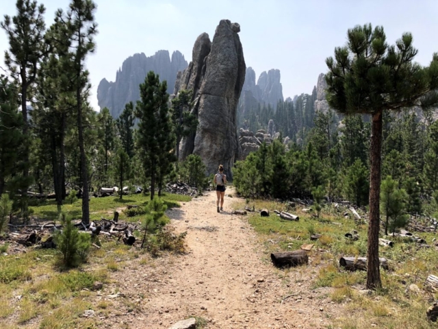 Emily running towards Cathedral Spires in Custer State Park