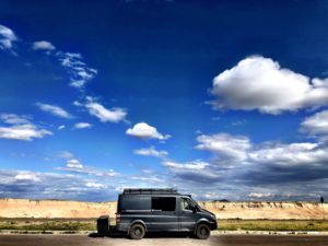 The Vantastic Life in Badlands National Park with blue sky and clouds