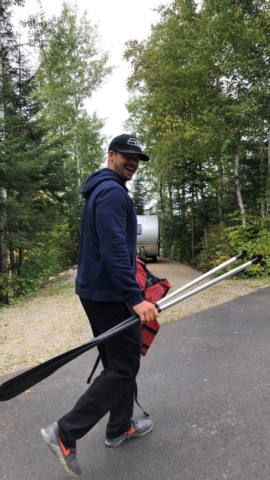 Joe carrying oars near Fall Lake in the Boundary Waters