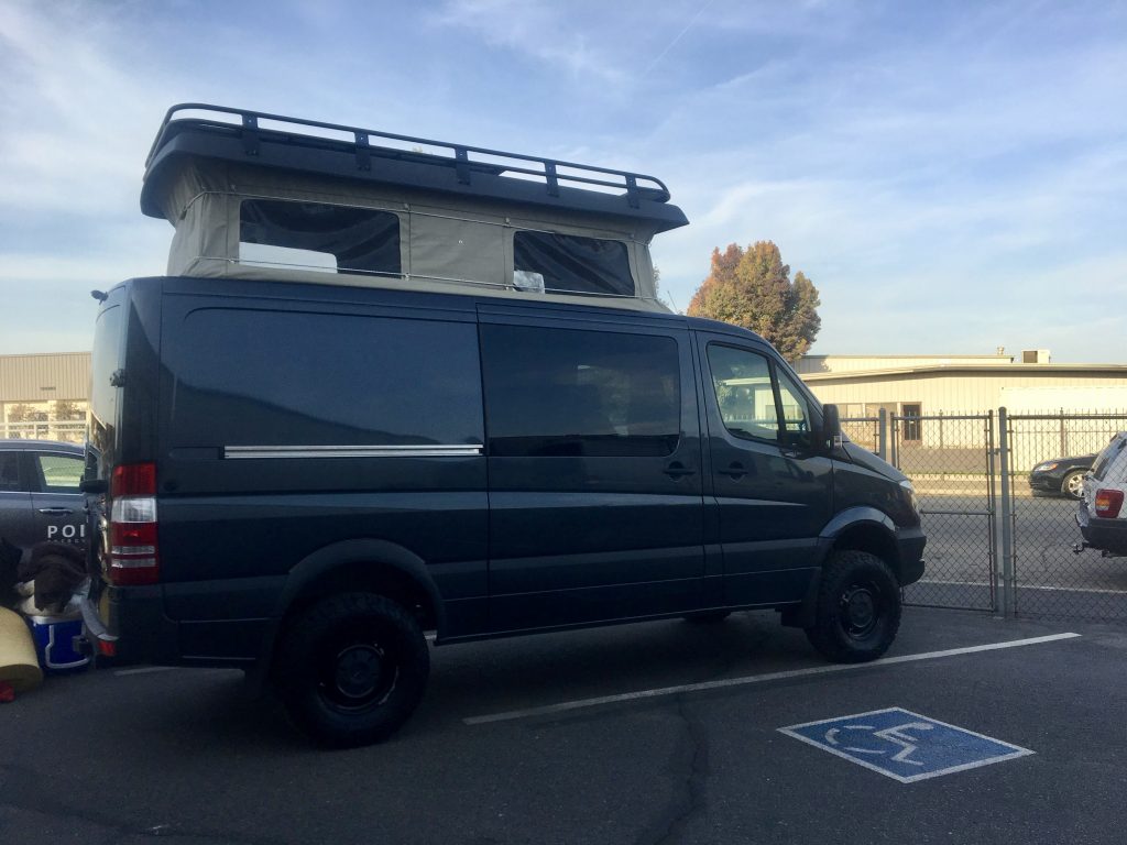 Our van with pop top installed in Sportsmobile parking lot