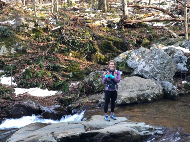 Emily during trail run in Shenandoah National Park next to river