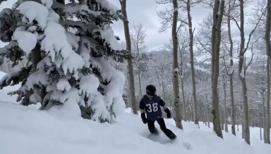 Joe snowboarding at Steamboat Springs on IKON pass with Seahawks jersey on