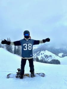 Joe snowboarding at Crystal Mountain with Mack Strong Seahawks jersey