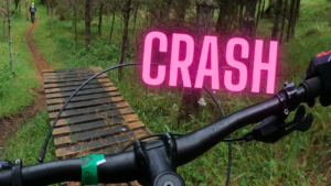 Emily dropping off a wood feature and crashing
