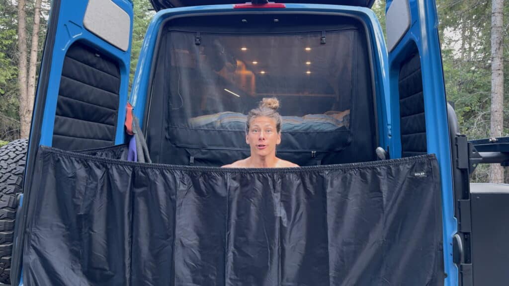 Van life outdoor shower in rear of van.