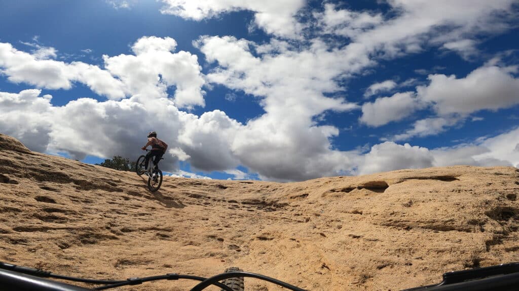 Riding the Pivot Firebird up a technical climb